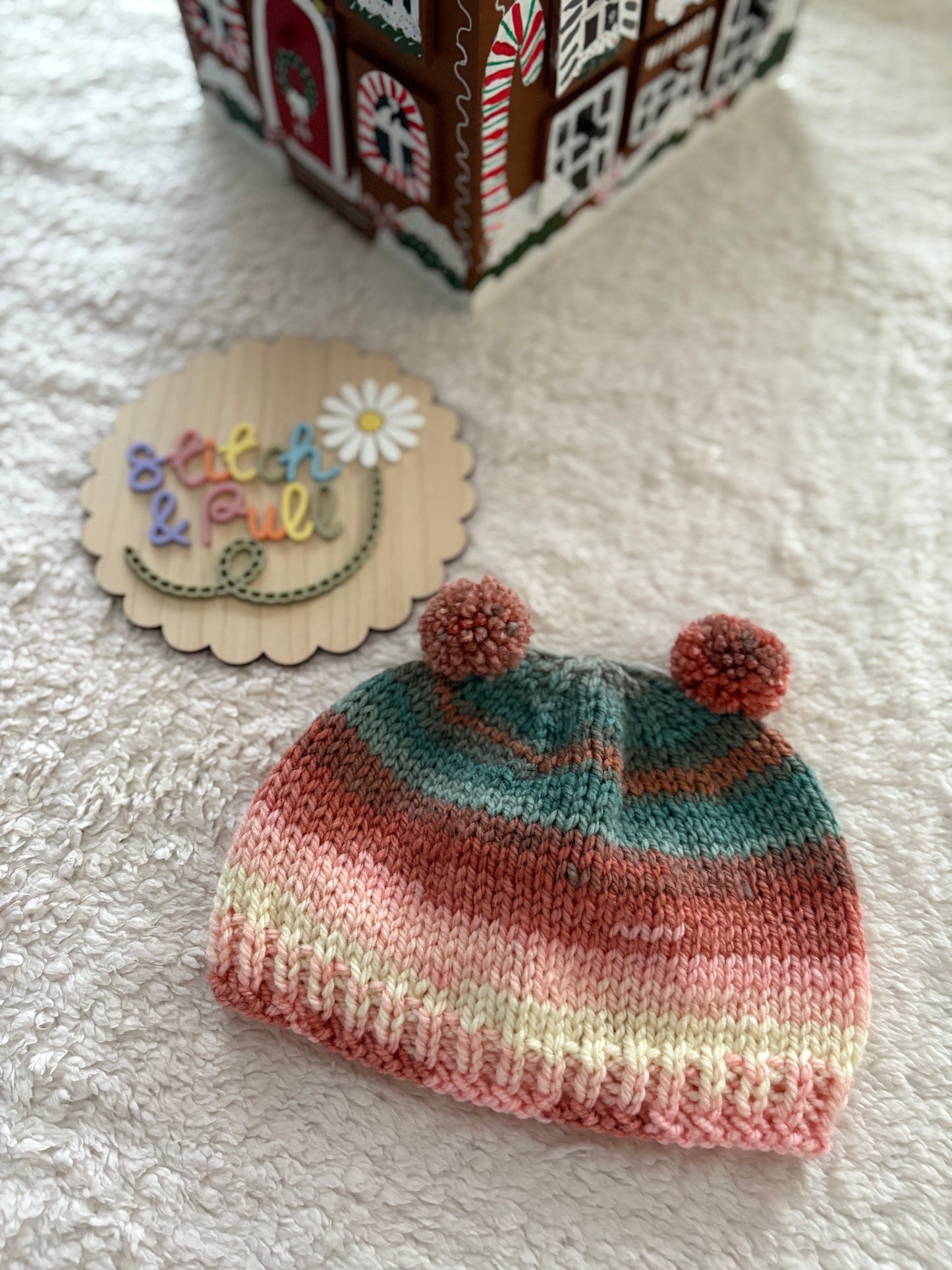 Personalisable knits - 2-3 years peach/blue/cream hat with 2 pom poms